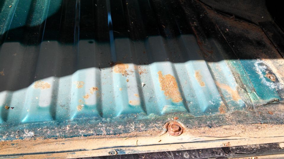 Corrugated truck bed interior with rust and dirt