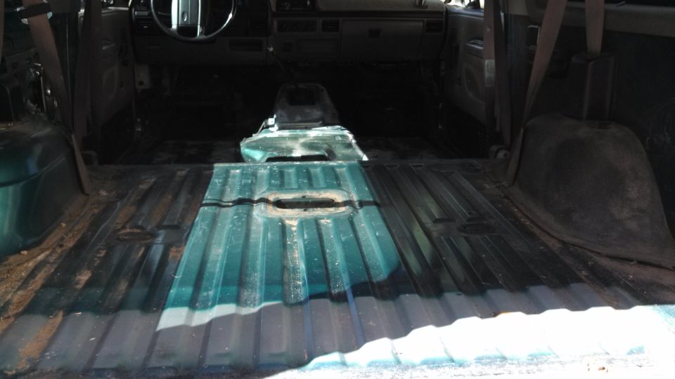1996 Ford Bronco interior showing removed rear seats and flooring