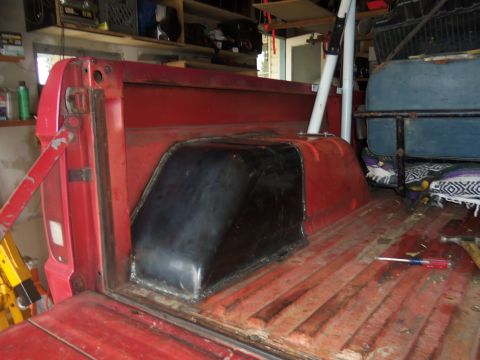 1968 Ford Bronco - The rear wheel well of a 1968 Ford Bronco has been enlarged and covered in black material.