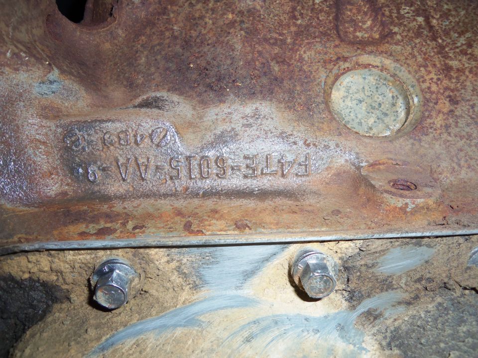 Close-up of a rusty engine block with casting numbers F4TE-6015-AA-8 visible