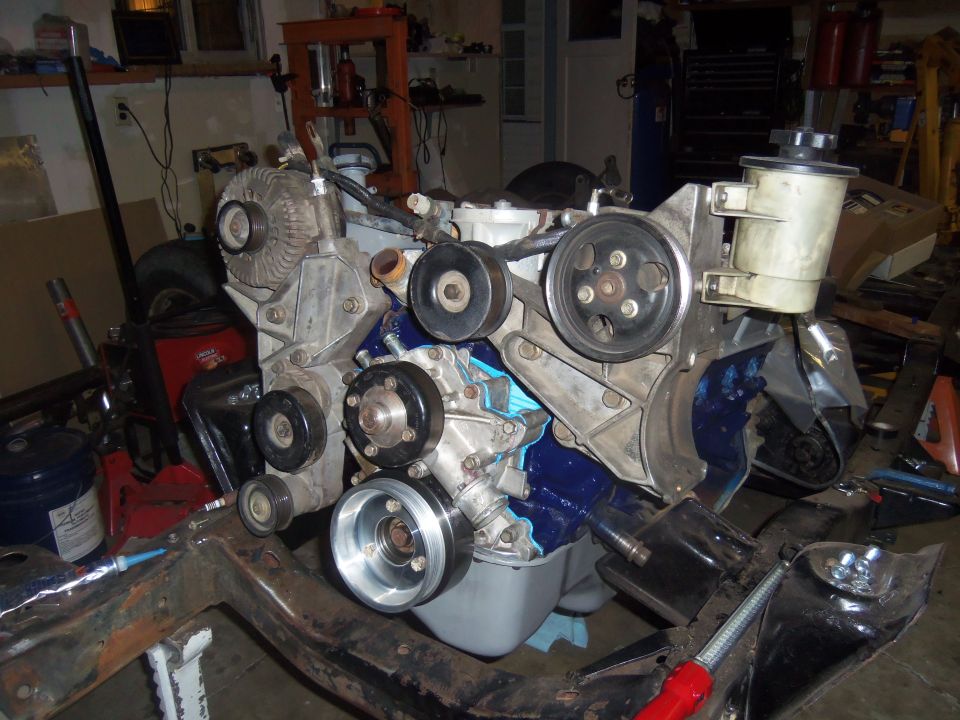 Ford V8 engine assembly with blue painted block and power steering reservoir
