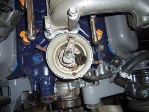 1968 Ford Bronco - The distributor cap and rotor assembly on an engine, showing fuel injectors and other engine components.