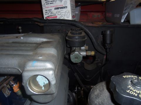 1968 Ford Bronco - Close-up view of engine components including the brake master cylinder and intake manifold.