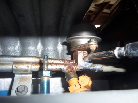1968 Ford Bronco - This image shows a close-up of a fuel injector and associated fuel rail components, not a 1968 Ford Bronco engine.