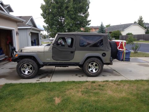 2005 Jeep Wrangler - Side view of a 2005 Jeep Wrangler Rubicon with a soft top, loaded with cargo on the rear.
