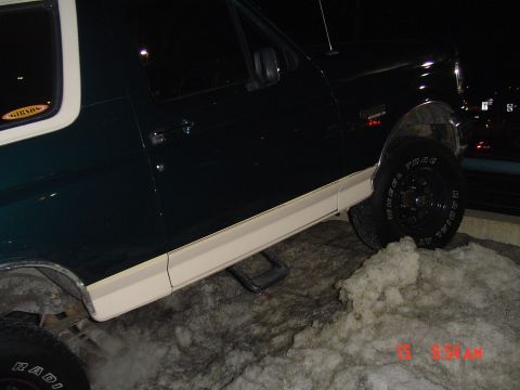 1993 Ford Bronco - This Ford Bronco is seen from the side, partially obscured by snow and ice.