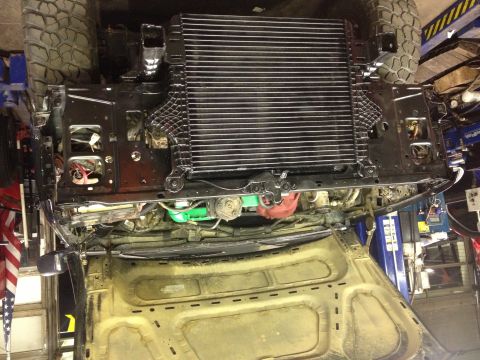 1995 Ford Bronco - The front end of a vehicle is shown with the radiator and some engine components exposed, possibly during a repair or modification.