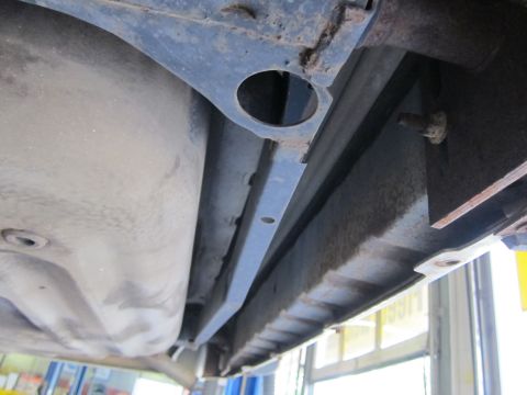 1991 Ford LTD Crown Victoria - Underside view of a vehicle's frame and fuel tank, showing structural components.