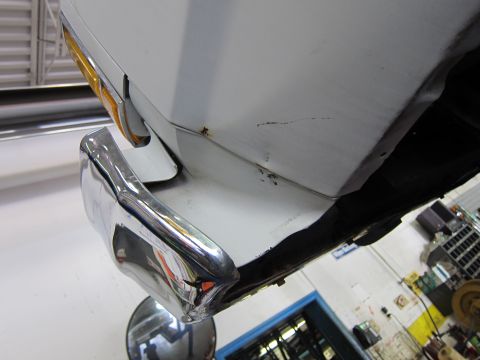 1991 Ford LTD Crown Victoria - Close-up of a chrome bumper and fender corner on a white vehicle.