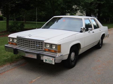 1991 Ford LTD Crown Victoria - White 1987 Ford Crown Victoria sedan parked outdoors, showing front 3/4 view with an antique license plate.
