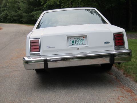 1991 Ford LTD Crown Victoria - This Ford Crown Victoria features a classic design with a prominent chrome bumper and an antique license plate from New Hampshire.