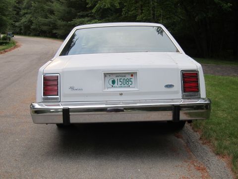 1991 Ford LTD Crown Victoria - Rear view of a white sedan with a chrome bumper and New Hampshire antique license plate.
