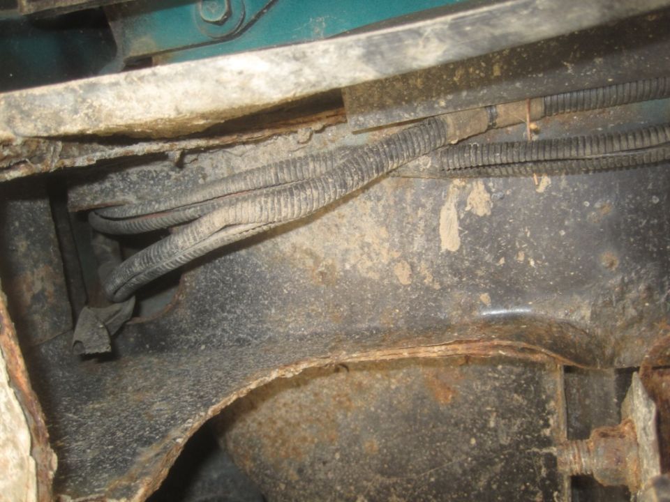 Corroded metal frame and wiring harness on a vehicle