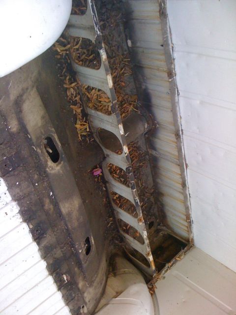 1964 Ford Ranchero - Debris has accumulated in the structural supports of the vehicle's bed area.