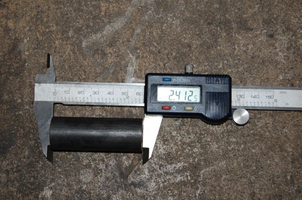 Digital caliper measures metal tube at 2.4125 inches