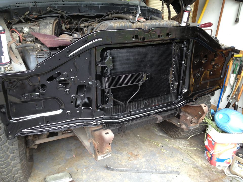 1979 Ford F-350 front end disassembled, showing radiator and engine components. Black painted frame