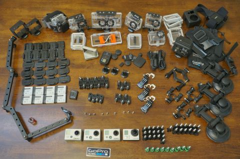 1993 Ford Taurus - A collection of GoPro cameras and their various accessories are neatly arranged on a wooden surface.