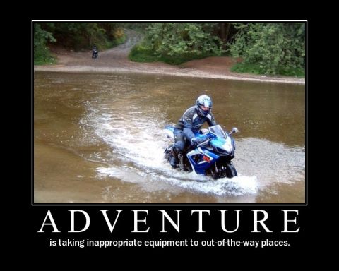 1996 Ford F-150 - A motorcycle rider navigates through a shallow body of water, with another motorcycle visible in the distance on a dirt path.