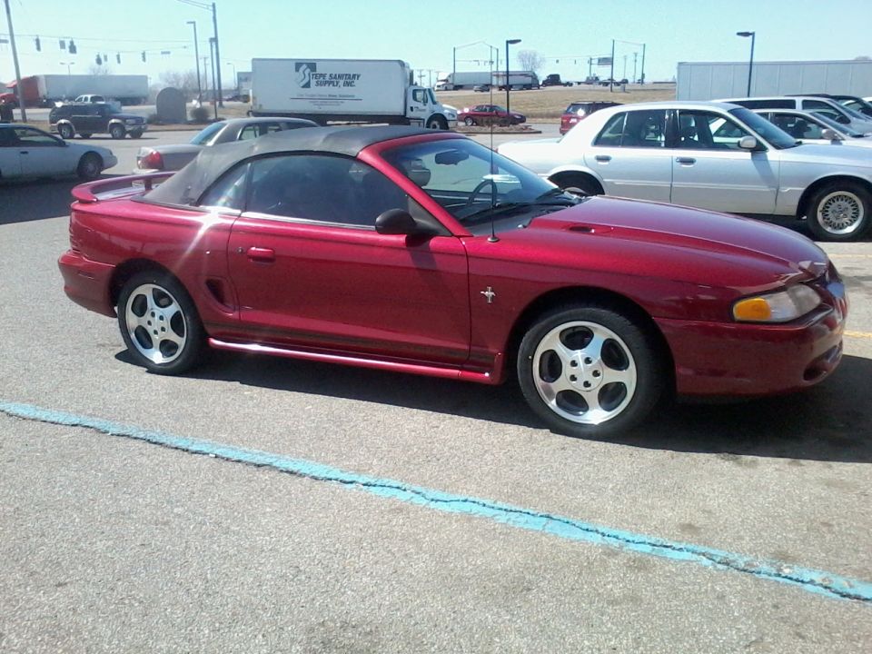 Red 1995 Ford Mustang convertible side view