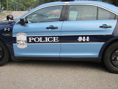 1991 Ford LTD Crown Victoria - Close-up of a two-tone blue Durham Police cruiser door showing the round shield emblem and white 'POLICE 911' lettering.