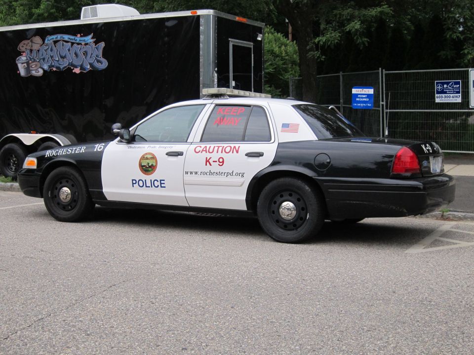 Black and white Rochester Police Ford Crown Victoria K-9 cruiser, side view