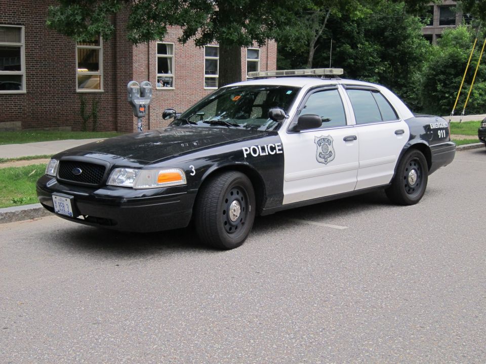 Black and white Ford Crown Victoria police car, front three-quarter view