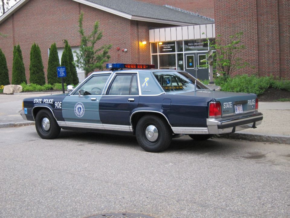 Blue State Police Ford LTD Crown Victoria sedan, rear three-quarter view