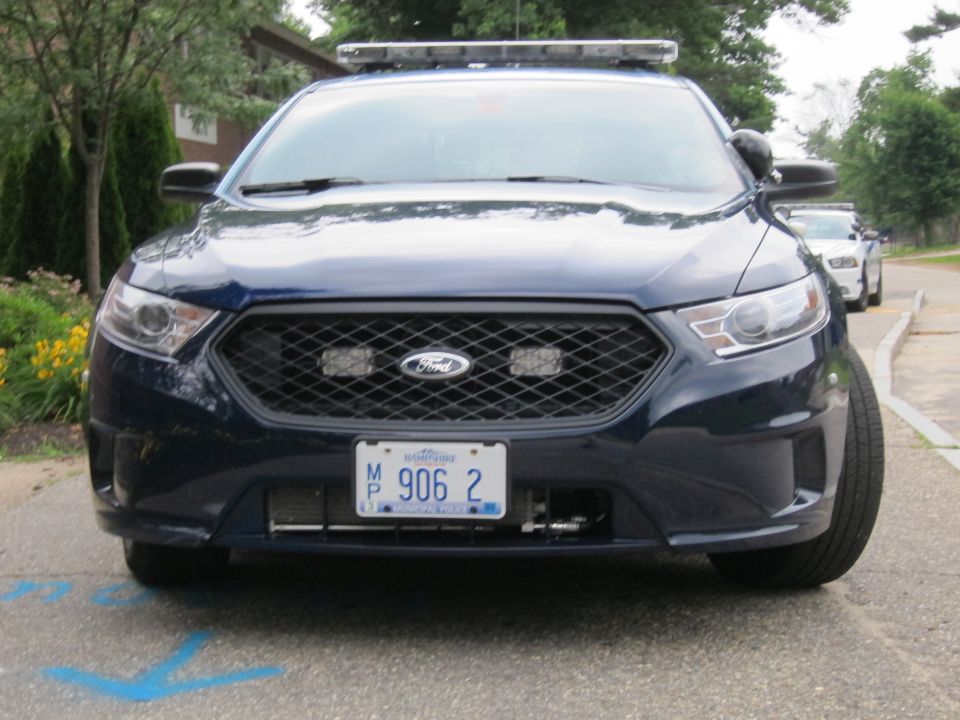 Dark blue Ford police sedan, front view, plate MP 906 2