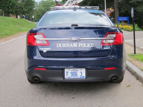 1991 Ford LTD Crown Victoria - Rear view of a dark blue Durham Police Ford sedan with Ford badge, lightbar and license plate MP 906 3.