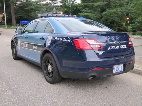 1991 Ford LTD Crown Victoria - two-tone blue Durham Police Ford sedan with Pride In Serving lettering and plate M 906 3 parked along a roadside.