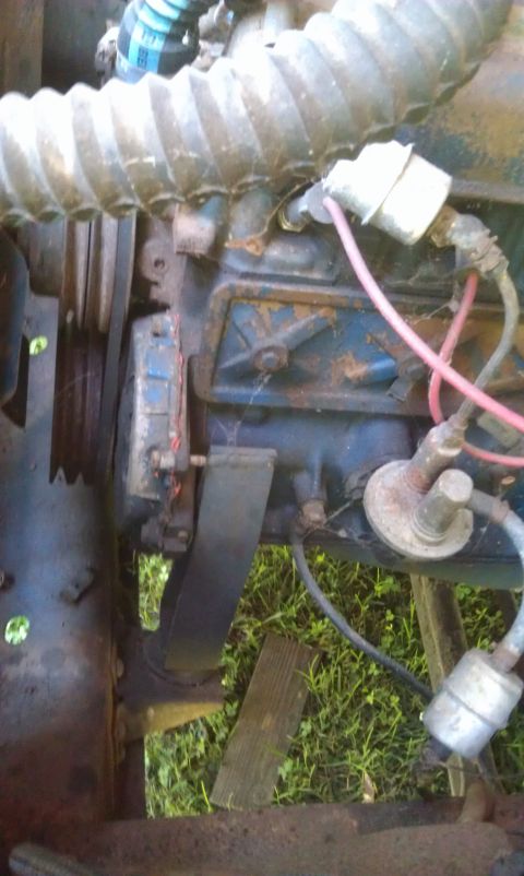1957 Ford F-100 - Engine components are visible in this close-up shot, with a ribbed hose and spark plug wires.