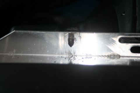1976 Ford Ranchero - A close-up view of a radiator component, showing a bolt and some wear marks.