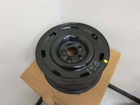 2001 Ford Crown Victoria - A single black steel wheel rim is shown, marked with '150' in white. It is placed on a cardboard box.