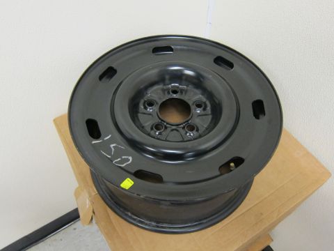 2001 Ford Crown Victoria - A black steel wheel rim is shown, with handwritten markings and a yellow sticker.