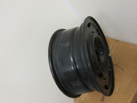 2001 Ford Crown Victoria - A single black steel wheel rim is shown, resting on a cardboard box.