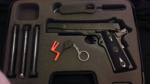 2000 Mercury Grand Marquis - A pistol and its accessories are laid out in a protective case.