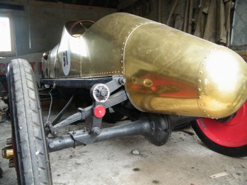 1909 Ford Model T - This brass-bodied race car has a distinctive teardrop shape and exposed suspension components.