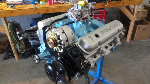 1972 Pontiac Trans Am - A Pontiac V8 engine assembly is shown on a stand, ready for installation or display.