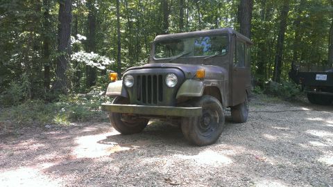 1978 Ford Bronco - This vintage Jeep FC-150 truck sits in a wooded area, with another vehicle parked nearby.