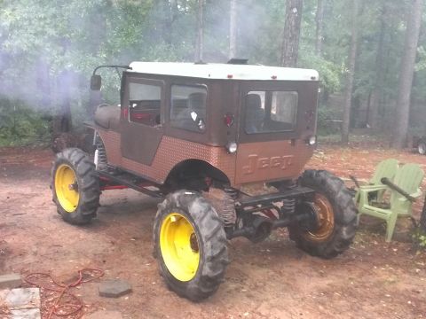 1978 Ford Bronco - This heavily modified Jeep features oversized tires and a unique cab structure, with "Jeep" branding on the rear.