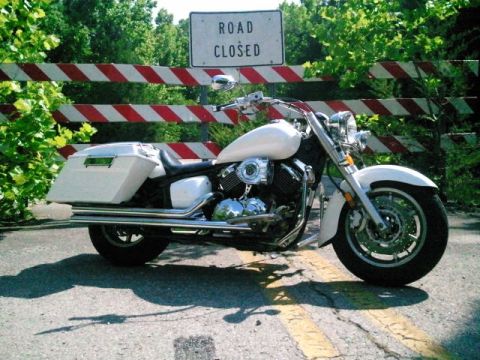 1995 Ford F-150 - A white cruiser motorcycle is parked in front of a 'Road Closed' sign and barrier.