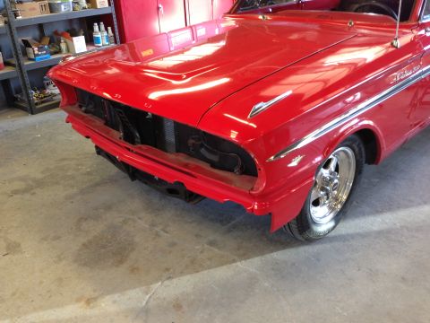 1964 Ford Fairlane - Front view of a red 1964 Ford Fairlane, showing its chrome trim and grille area.