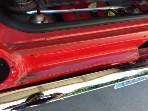 1964 Ford Fairlane - Close-up of the side of a 1964 Ford Fairlane, highlighting the door sill and bumper.