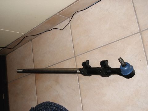 1996 Ford Bronco - A steering linkage component is shown against a tiled background.