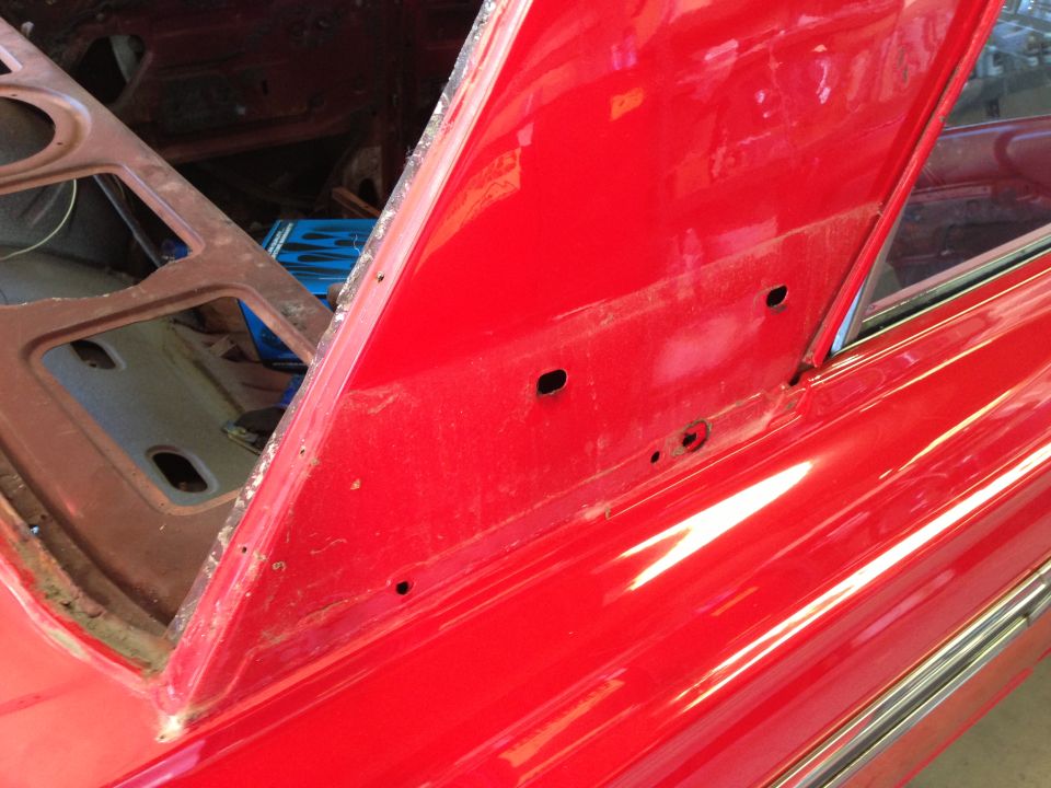 Red car interior with open trunk area and chrome trim