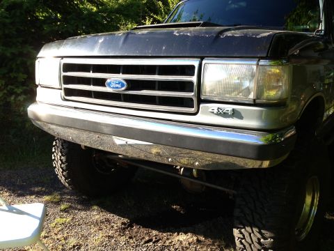 1989 Ford Bronco - Front view of a dark gray Ford truck, showing its grille, bumper, and "4x4" badging.