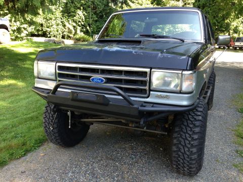 1989 Ford Bronco - Front view of a 1989 Ford Bronco, modified with an aftermarket bumper and large tires.