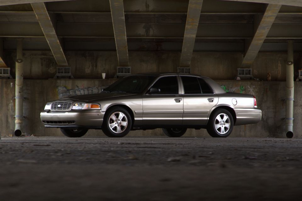 Silver 2005 Ford Crown Victoria sedan parked under a concrete overpass