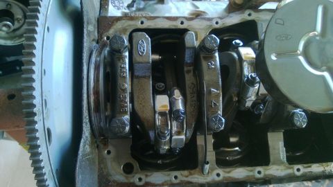 1994 Ford Bronco - Engine crankshaft and connecting rods with Ford logos visible on parts.