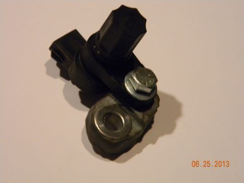 1995 Ford Bronco - Close-up of a speed sensor assembly, including its mounting bracket and a hex bolt.